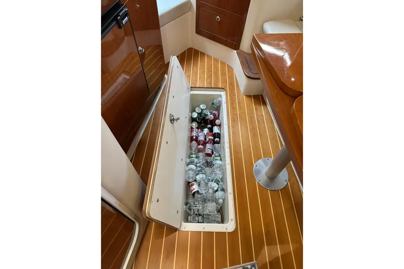 Slide: The Image of Storage compartment with drinks on a 2005 Regal 3360 Window Express boat. - 23