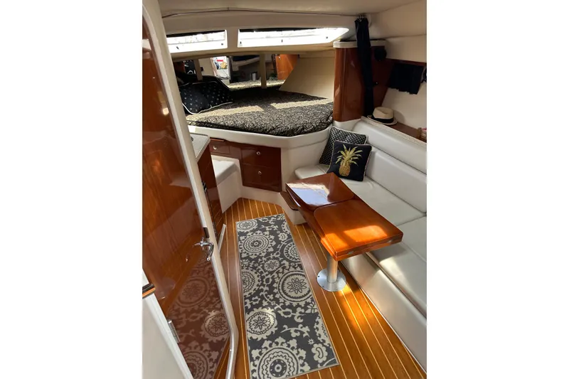 Slide: The Image of Interior of 2005 Regal 3360 Window Express yacht with cozy seating and elegant decor. - 24