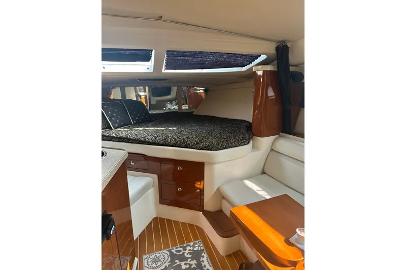 Slide: The Image of Luxurious interior of 2005 Regal 3360 Window Express yacht with cozy bed and seating area. - 25