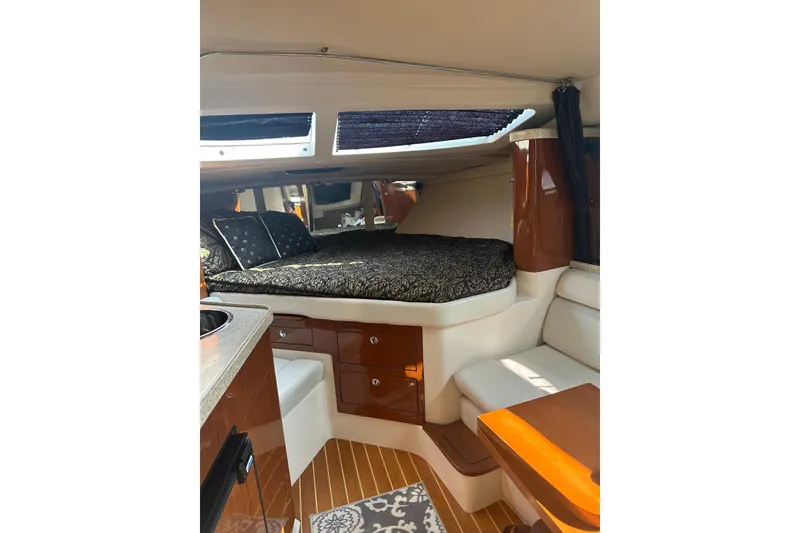 Slide: The Image of Interior of 2005 Regal 3360 Window Express yacht with cozy bed and seating area. - 27