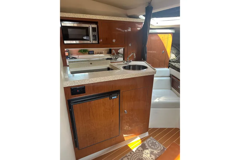Slide: The Image of 2005 Regal 3360 Window Express yacht interior with kitchenette, microwave, and sink. - 28