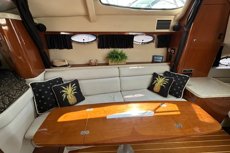 Slide: The Image of Interior of 2005 Regal 3360 Window Express yacht with cozy seating and decorative pillows. - 29