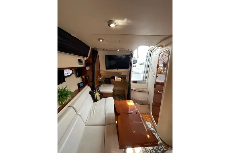 Slide: The Image of Interior of 2005 Regal 3360 Window Express yacht, featuring elegant seating and modern amenities. - 30