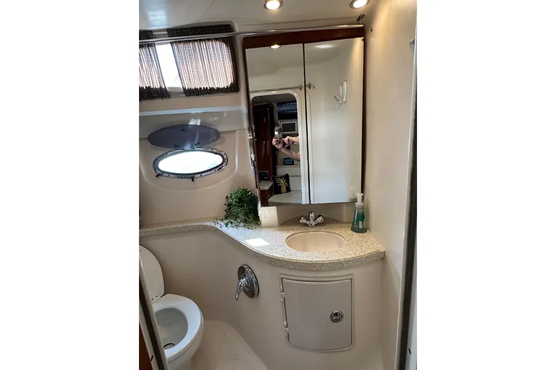 Slide: The Image of 2005 Regal 3360 Window Express bathroom with sink, mirror, and porthole window. - 33