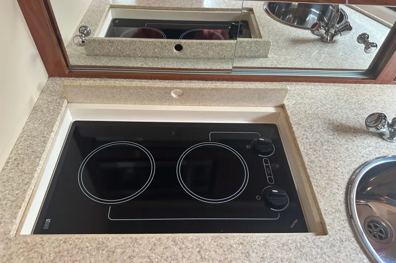 Slide: The Image of 2005 Regal 3360 Window Express kitchen with electric stovetop and sink. - 34