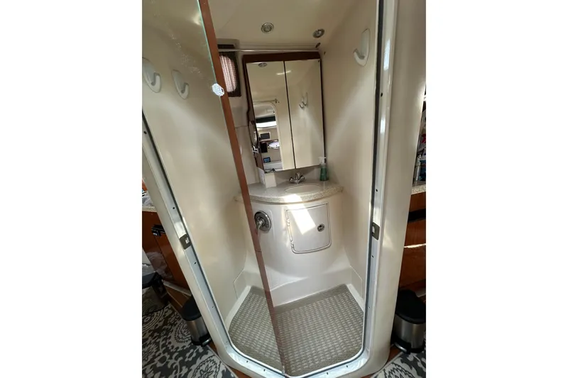 Slide: The Image of Compact bathroom in 2005 Regal 3360 Window Express yacht, featuring sink and mirror. - 35