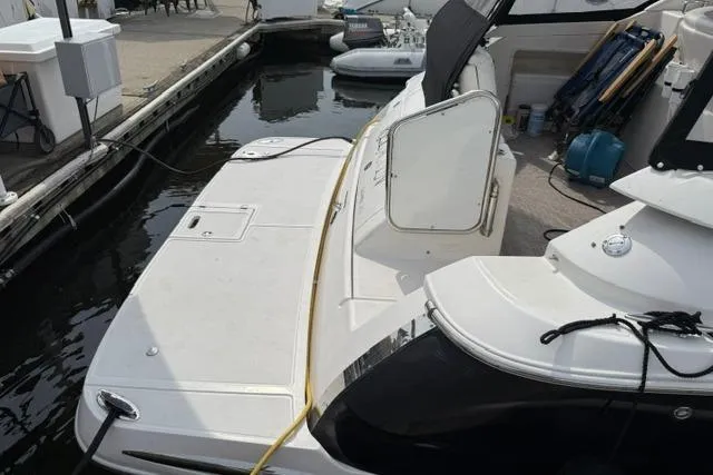 Slide: The Image of 2005 Regal 3360 Window Express boat docked at marina, showing swim platform and deck. - 6