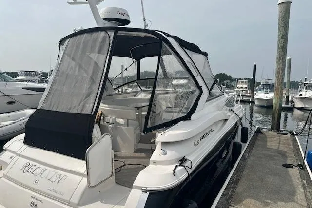 Slide: The Image of 2005 Regal 3360 Window Express boat docked at marina with protective canopy. - 7