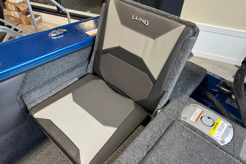 Slide: The Image of 2026 Lund 1875 Crossover XS boat seat with gray and black upholstery. - 14