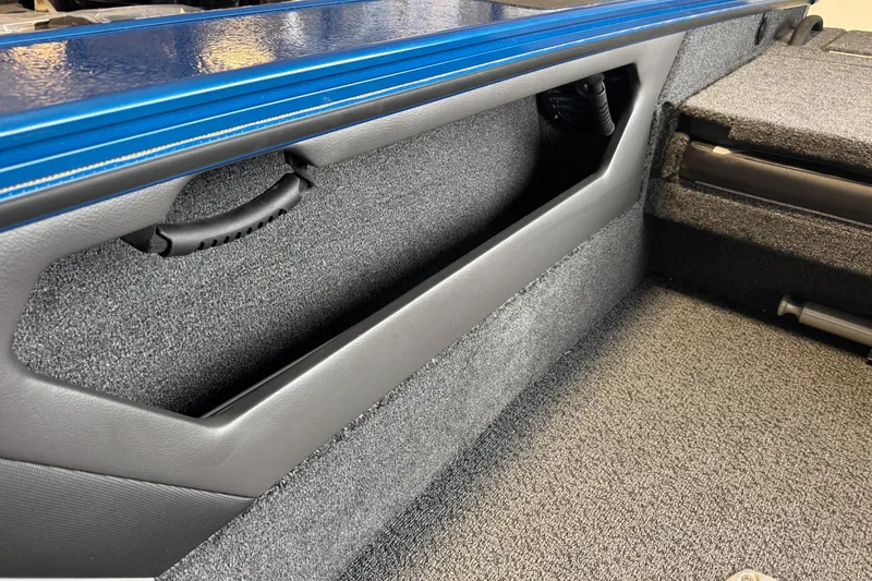 Slide: The Image of 2026 Lund 1875 Crossover XS interior detail with blue trim and storage compartment. - 15