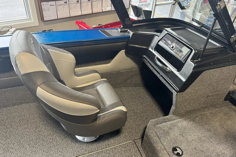 Slide: The Image of 2026 Lund 1875 Crossover XS boat interior with sleek seating and modern dashboard design. - 17
