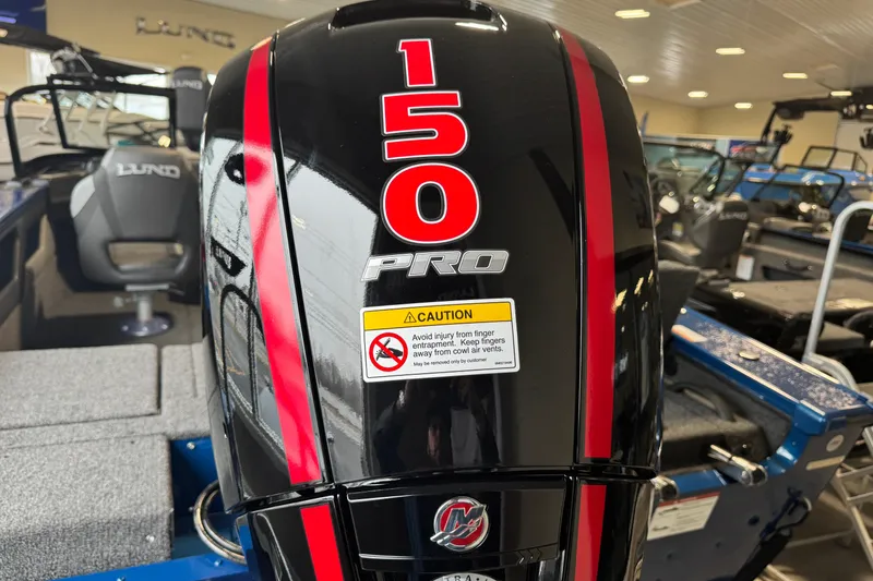 Slide: The Image of 2026 Lund 1875 Crossover XS with 150 Pro outboard motor in showroom. - 23