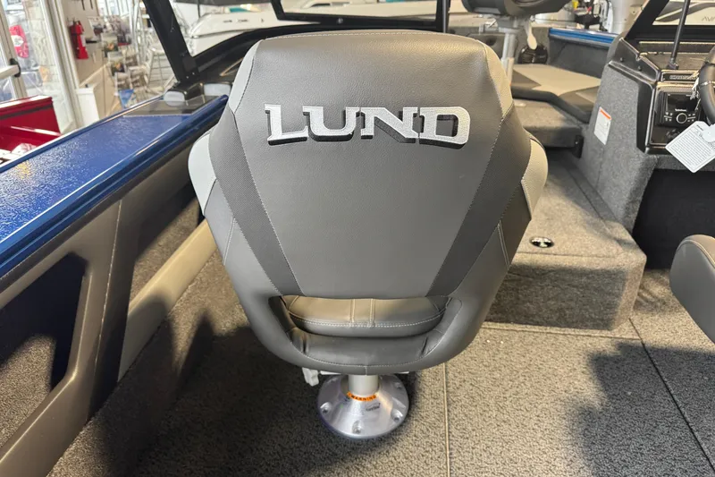 Slide: The Image of 2026 Lund 1875 Crossover XS boat seat with logo, showcasing interior design. - 24