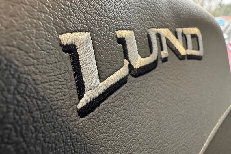 Slide: The Image of Close-up of Lund logo on 2026 Lund 1875 Crossover XS boat seat. - 4