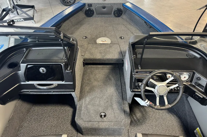 Slide: The Image of Interior view of 2026 Lund 1875 Crossover XS boat, featuring steering wheel and dashboard. - 7