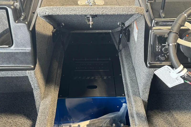 Slide: The Image of Interior view of 2026 Lund 1875 Crossover XS boat cockpit and storage area. - 8