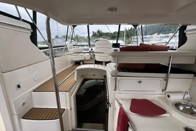 Slide: The Image of Interior view of 1999 Sea Ray 420 Aft Cabin yacht with seating and stairs. - 10