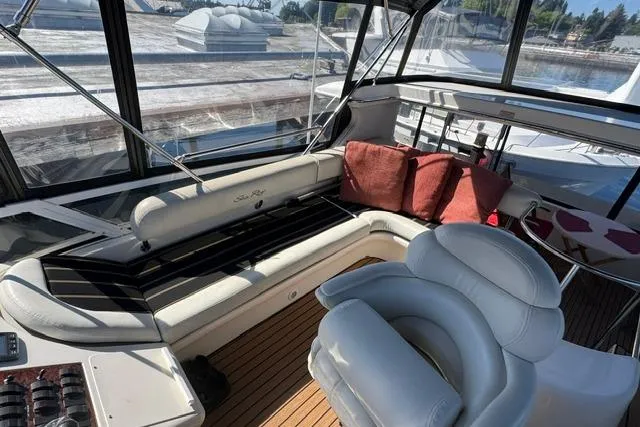 Slide: The Image of 1999 Sea Ray 420 Aft Cabin yacht interior with plush seating and scenic views. - 15