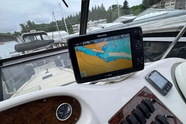 Slide: The Image of Cockpit view of a 1999 Sea Ray 420 Aft Cabin with navigation equipment. - 18