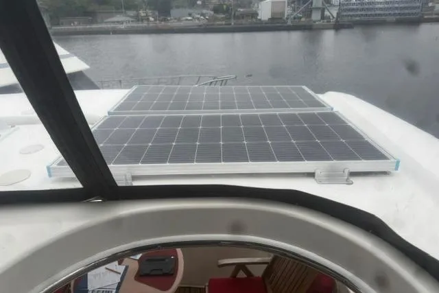 Slide: The Image of Solar panels on a 1999 Sea Ray 420 Aft Cabin yacht, docked by the water. - 19
