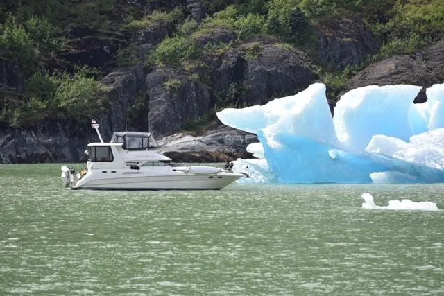 Slide: The Image of Sea Ray 420 Aft Cabin yacht near iceberg in scenic waters, 1999 model. - 2