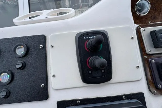 Slide: The Image of Control panel of a 1999 Sea Ray 420 Aft Cabin boat with Lewmar switches. - 21