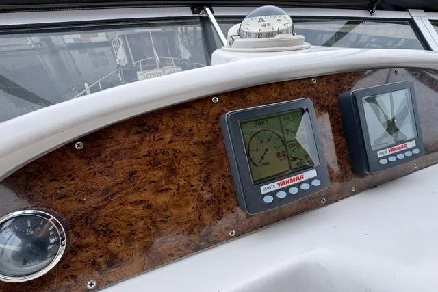 Slide: The Image of Dashboard of 1999 Sea Ray 420 Aft Cabin with Yanmar gauges and compass. - 27