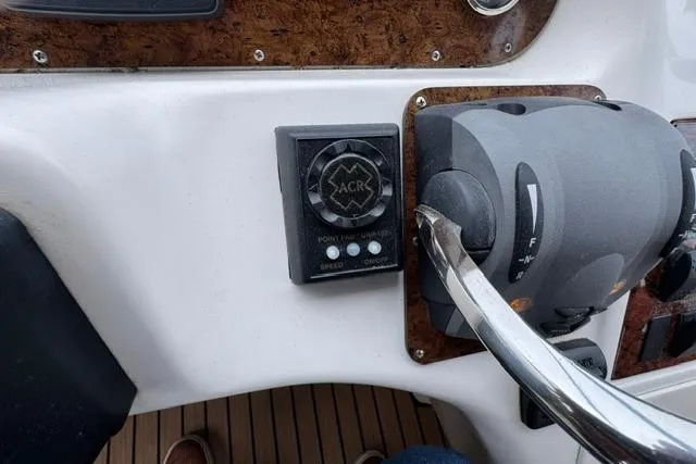Slide: The Image of Control panel of a 1999 Sea Ray 420 Aft Cabin boat with throttle and ACR device. - 28