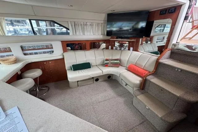 Slide: The Image of Luxurious 1999 Sea Ray 420 Aft Cabin interior with plush seating and modern amenities. - 30
