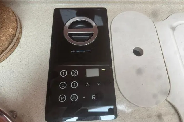 Slide: The Image of Control panel on a 1999 Sea Ray 420 Aft Cabin yacht, featuring buttons and a dial. - 36