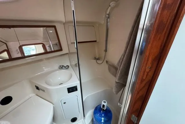 Slide: The Image of 1999 Sea Ray 420 Aft Cabin bathroom with sink, shower, and mirror. - 40