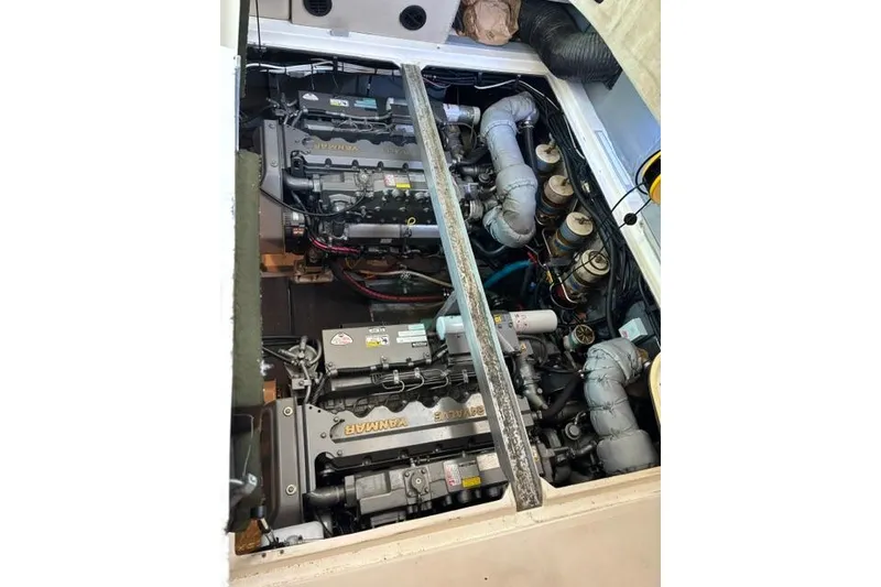 Slide: The Image of Engine compartment of a 1999 Sea Ray 420 Aft Cabin boat, showcasing dual Yanmar engines. - 48