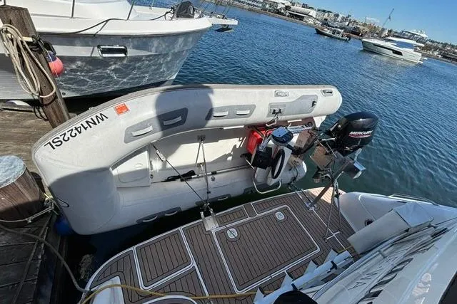 Slide: The Image of 1999 Sea Ray 420 Aft Cabin yacht docked with inflatable boat and Mercury motor. - 5