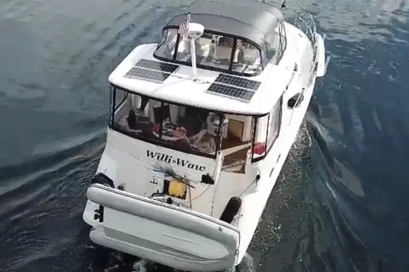 Slide: The Image of 1999 Sea Ray 420 Aft Cabin yacht cruising on water, rear view. - 6