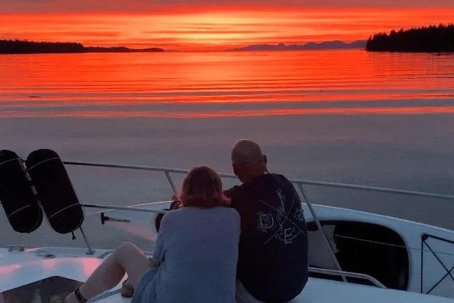 Slide: The Image of Couple enjoying sunset on 1999 Sea Ray 420 Aft Cabin yacht. - 9