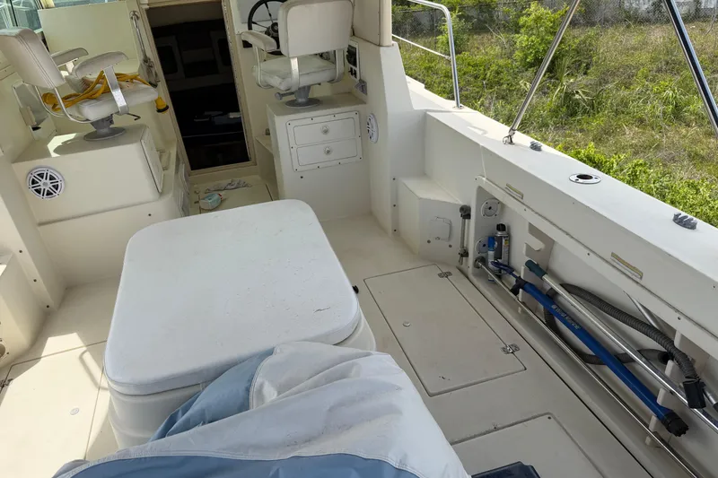 Slide: The Image of Interior view of a 2000 Albin 28 Tournament Express boat, featuring seating and storage. - 10
