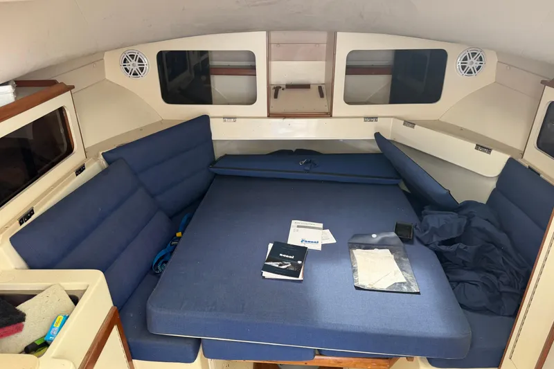 Slide: The Image of Interior cabin of 2000 Albin 28 Tournament Express with blue seating and storage. - 11