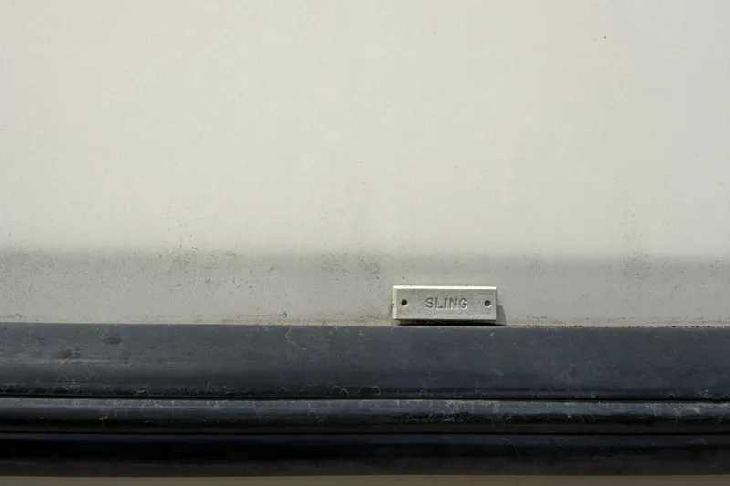Slide: The Image of Close-up of a 2000 Albin 28 Tournament Express with a "SLING" label. - 28