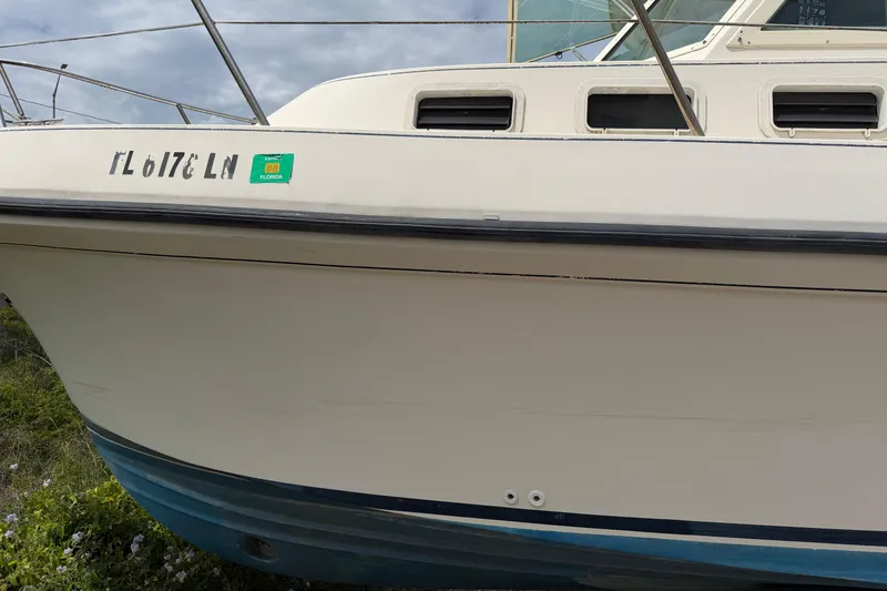 Slide: The Image of 2000 Albin 28 Tournament Express boat with Florida registration, docked outdoors. - 29