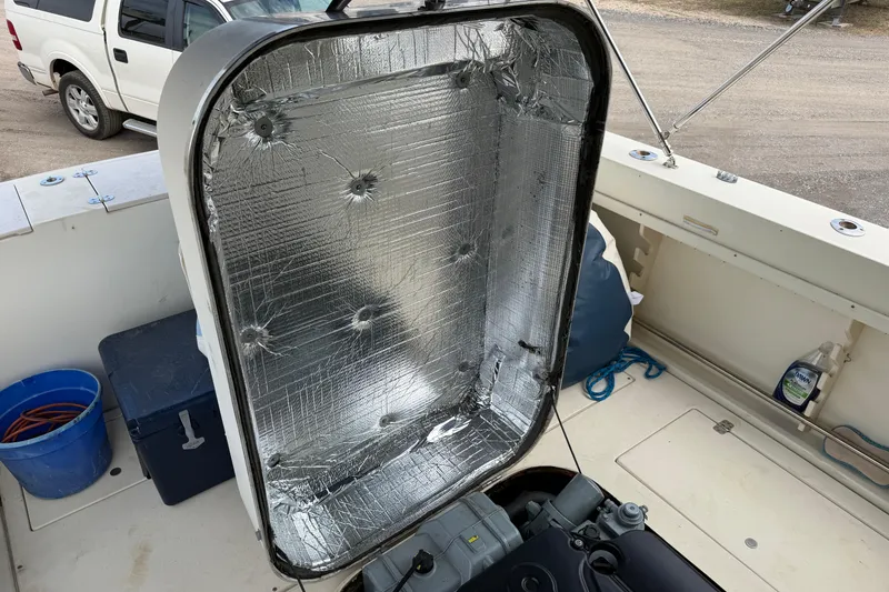 Slide: The Image of Engine compartment of a 2000 Albin 28 Tournament Express boat, showing insulation and equipment. - 30