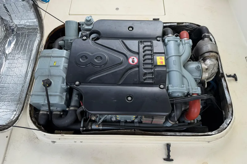 Slide: The Image of Engine compartment of a 2000 Albin 28 Tournament Express boat, showcasing detailed machinery. - 31