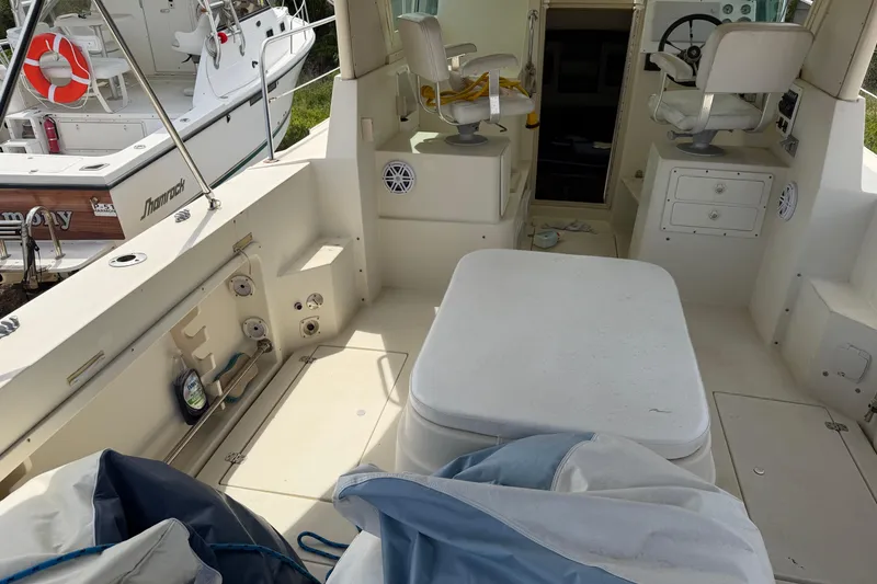 Slide: The Image of Interior view of a 2000 Albin 28 Tournament Express boat, featuring seating and control area. - 9