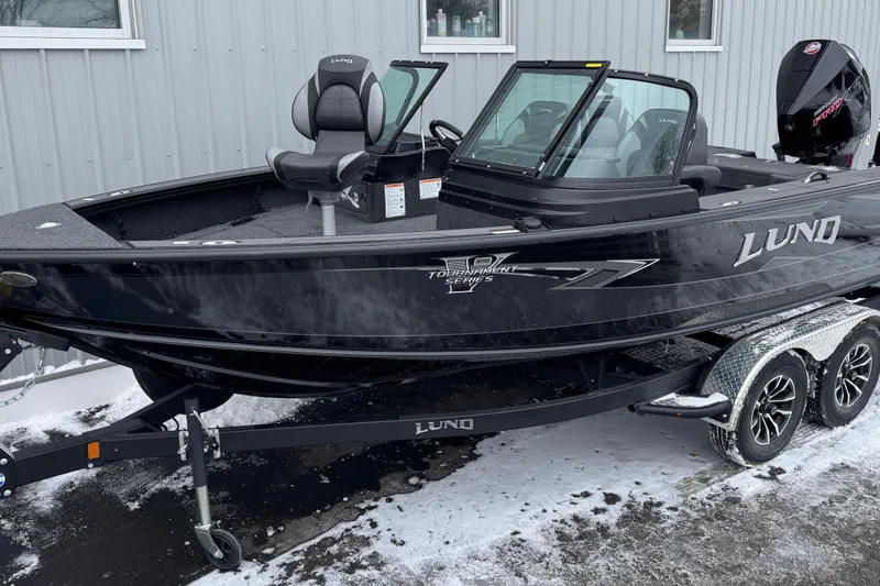 The Image of 2026 Lund 1975 Pro-V Sport boat on trailer, parked in snowy area. - 1