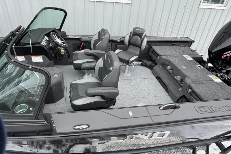 Slide: The Image of 2026 Lund 1975 Pro-V Sport boat interior with modern seating and controls. - 10