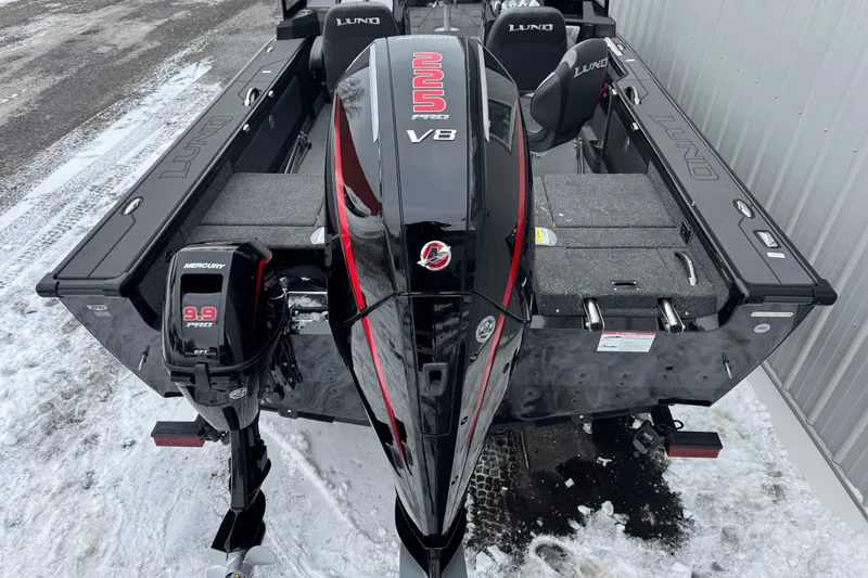 Slide: The Image of 2026 Lund 1975 Pro-V Sport boat with Mercury 9.9 Pro outboard motor in snowy setting. - 11