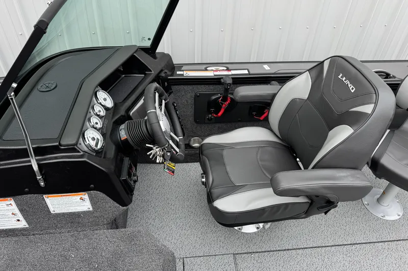 Slide: The Image of Interior of 2026 Lund 1975 Pro-V Sport boat with steering console and cushioned seat. - 17
