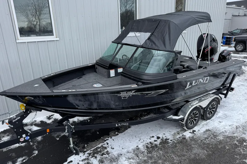 Slide: The Image of 2026 Lund 1975 Pro-V Sport boat on trailer, parked in snowy area. - 2