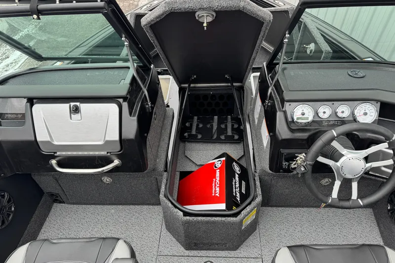 Slide: The Image of 2026 Lund 1975 Pro-V Sport boat interior with Mercury parts box in storage compartment. - 6
