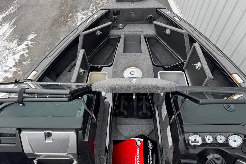Slide: The Image of Interior view of 2026 Lund 1975 Pro-V Sport boat with open storage compartments. - 7