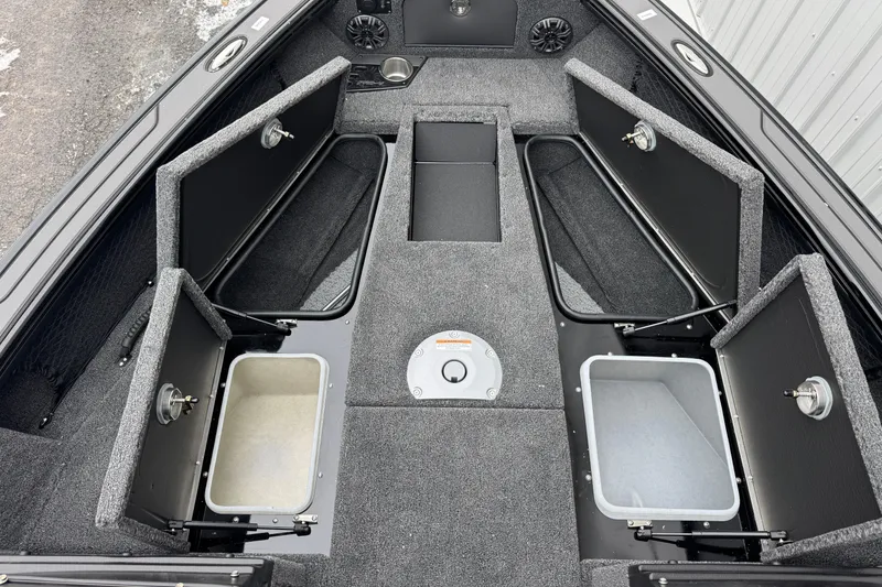 Slide: The Image of 2026 Lund 1975 Pro-V Sport boat interior with open storage compartments and carpeted flooring. - 8